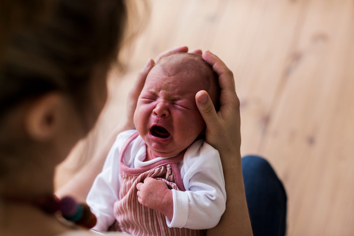 Mother Holding Crying Newborn Baby