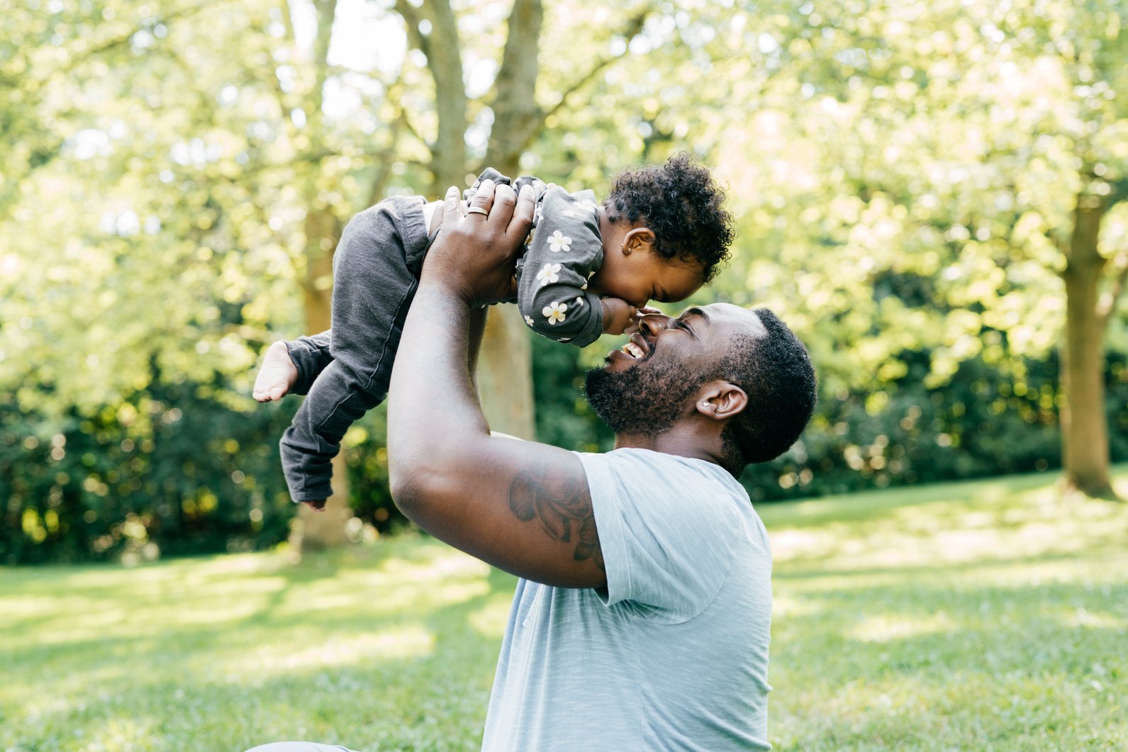 Dad playing with his baby daughter outdoor