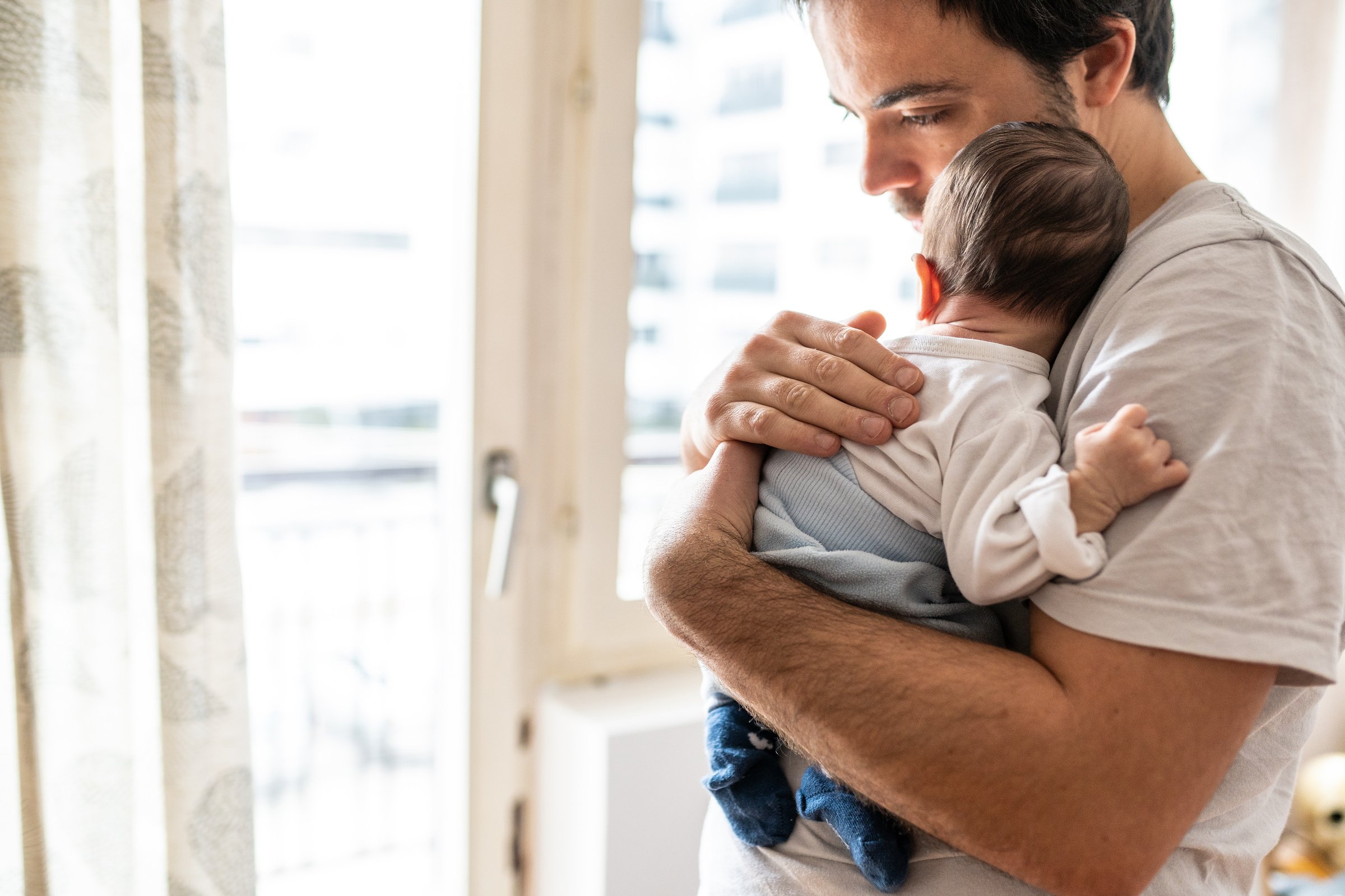 Dad holding  newborn baby