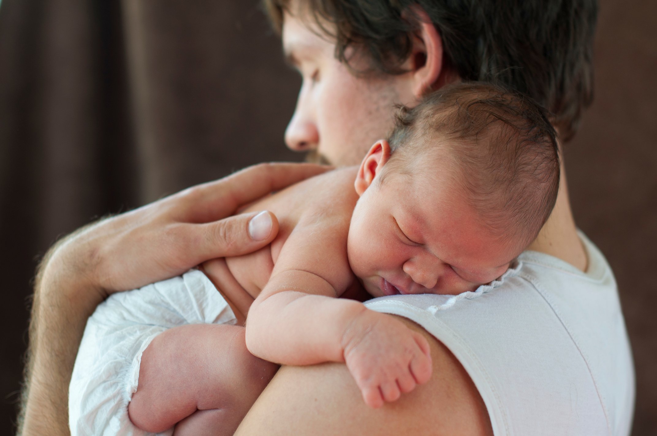 Dad Holding Newborn Baby